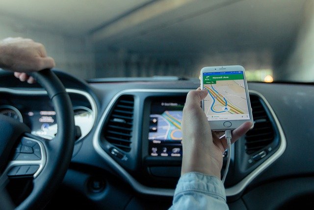 chauffeur tenant smartphone avec itinéraire affiché